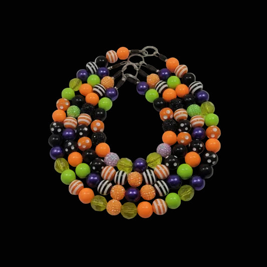 Colorful beaded dog chain on black background