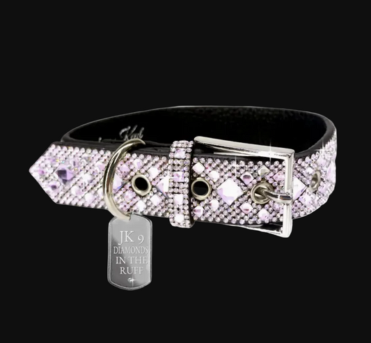 Dog collar with pink crystals and a silver tag on a white background