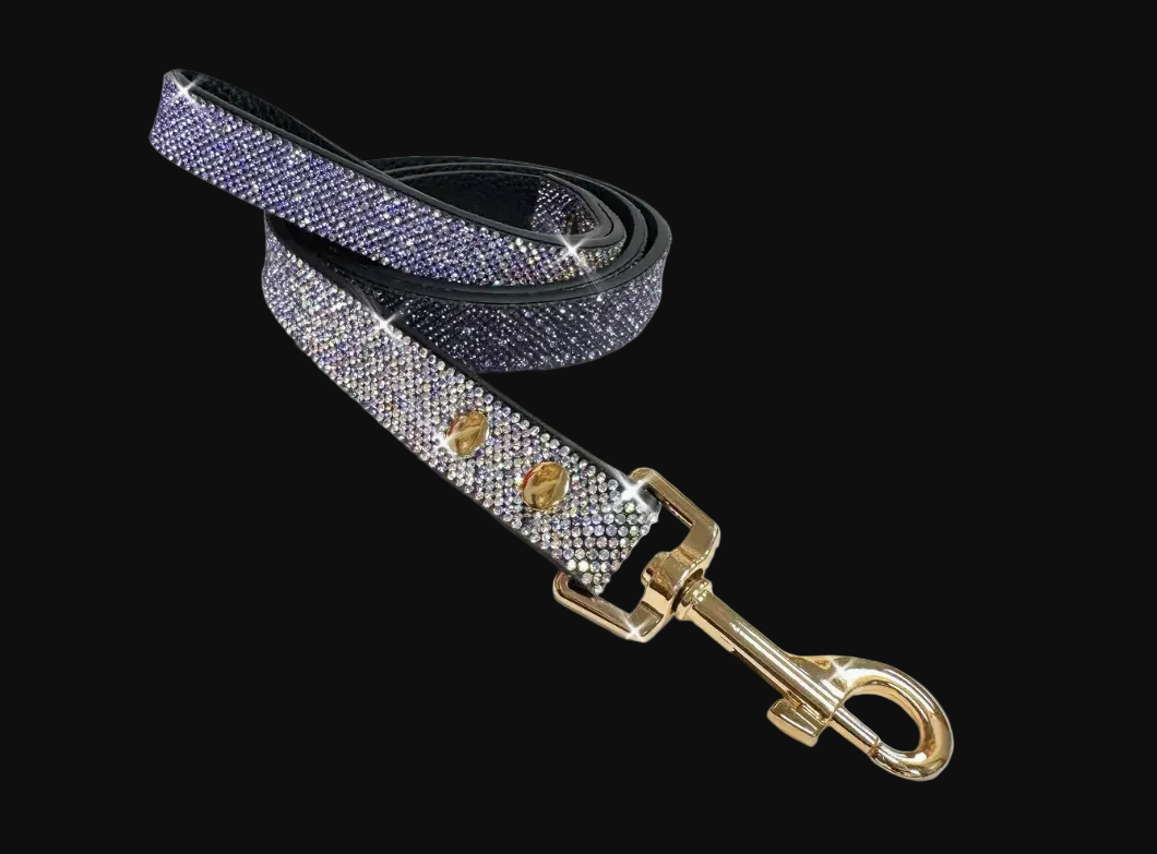 Decorative dog leash with purple glittery strap and gold hardware on a white background