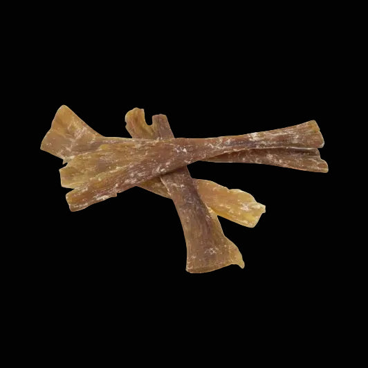Three dog chew treats on a white background