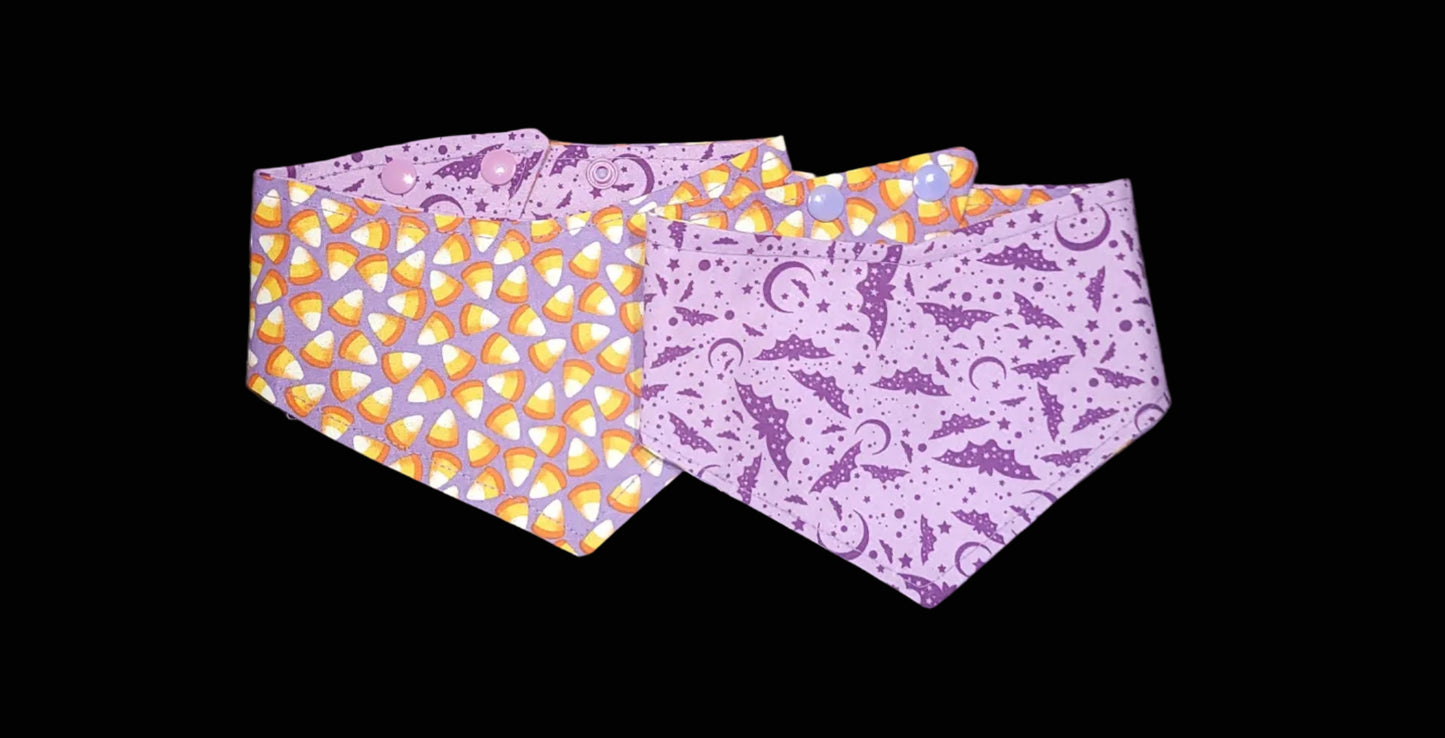 Two fabric bands with Halloween-themed patterns on a dark surface