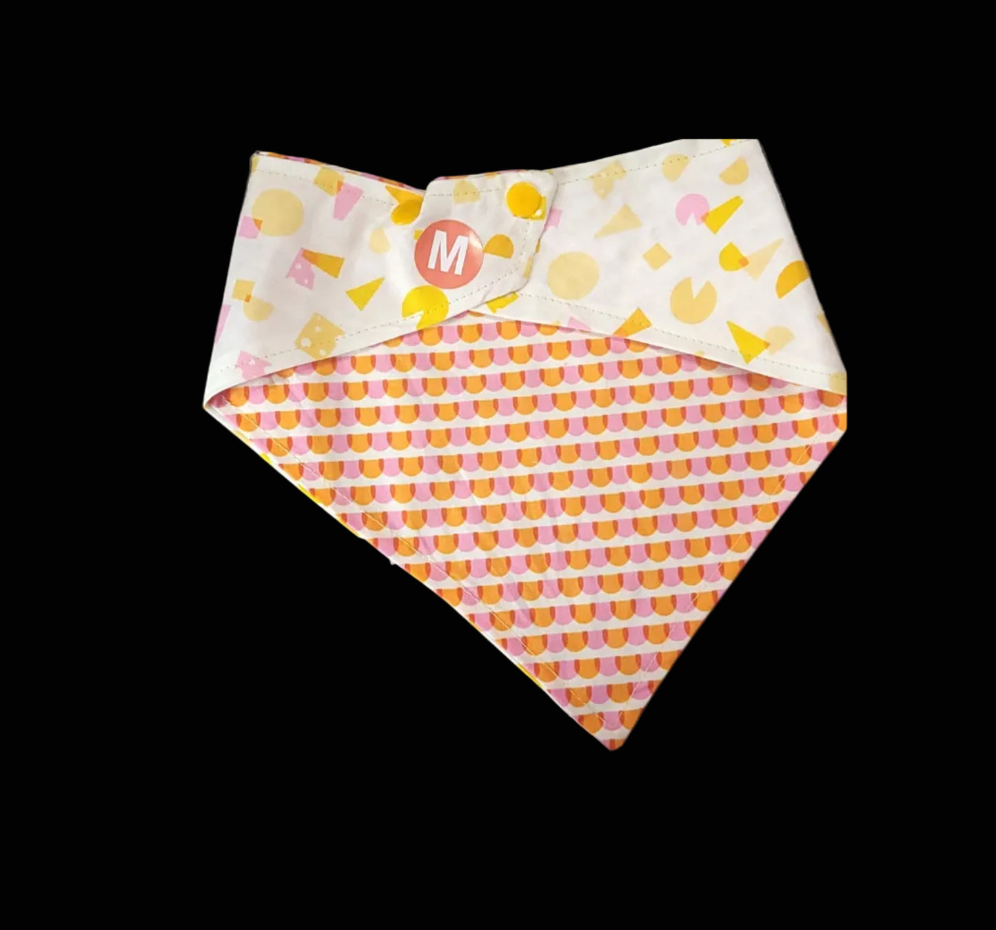Two patterned fabric swatches on a dark surface