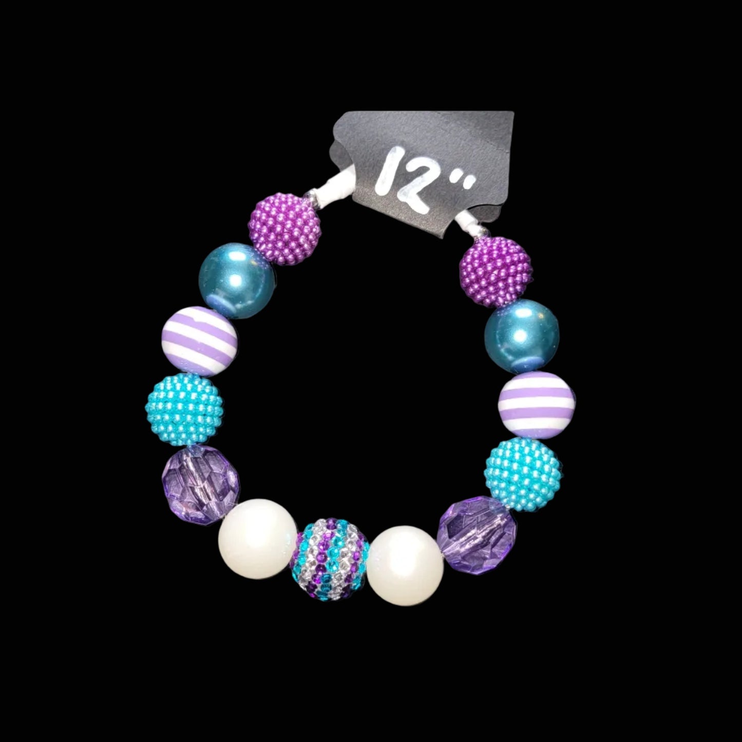 Colorful beaded bracelet with a size tag on a black background