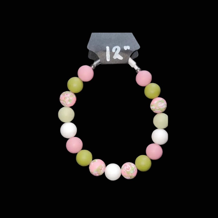 Necklace with colorful beads on a gray background
