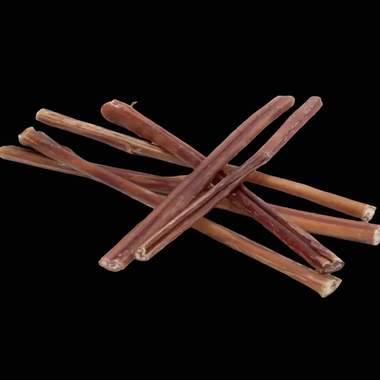 Stack of brown dog chew sticks on a black background