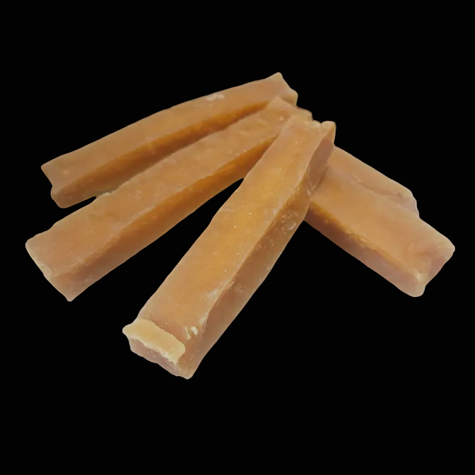 Three pieces of dog chew treat on a black background