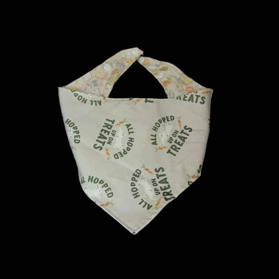 Dog bandana with text and floral pattern on a wooden surface